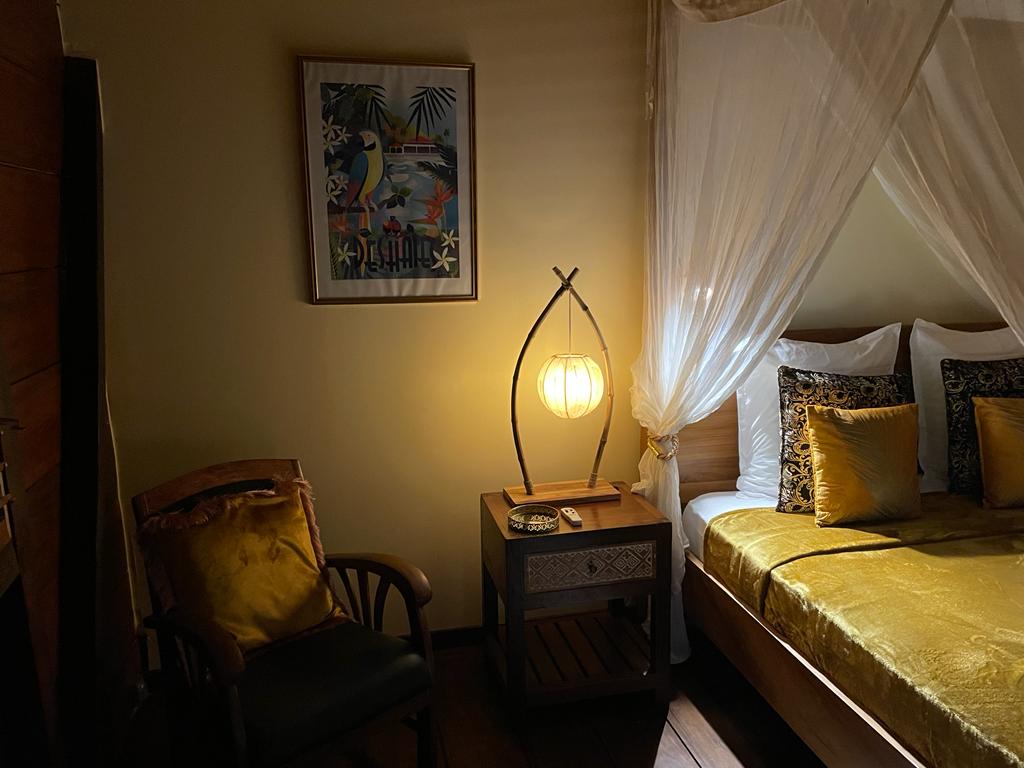 Two bedrooms with separate toilets and showers, queen-size bed, mosquito net, fan, and air conditioning.
