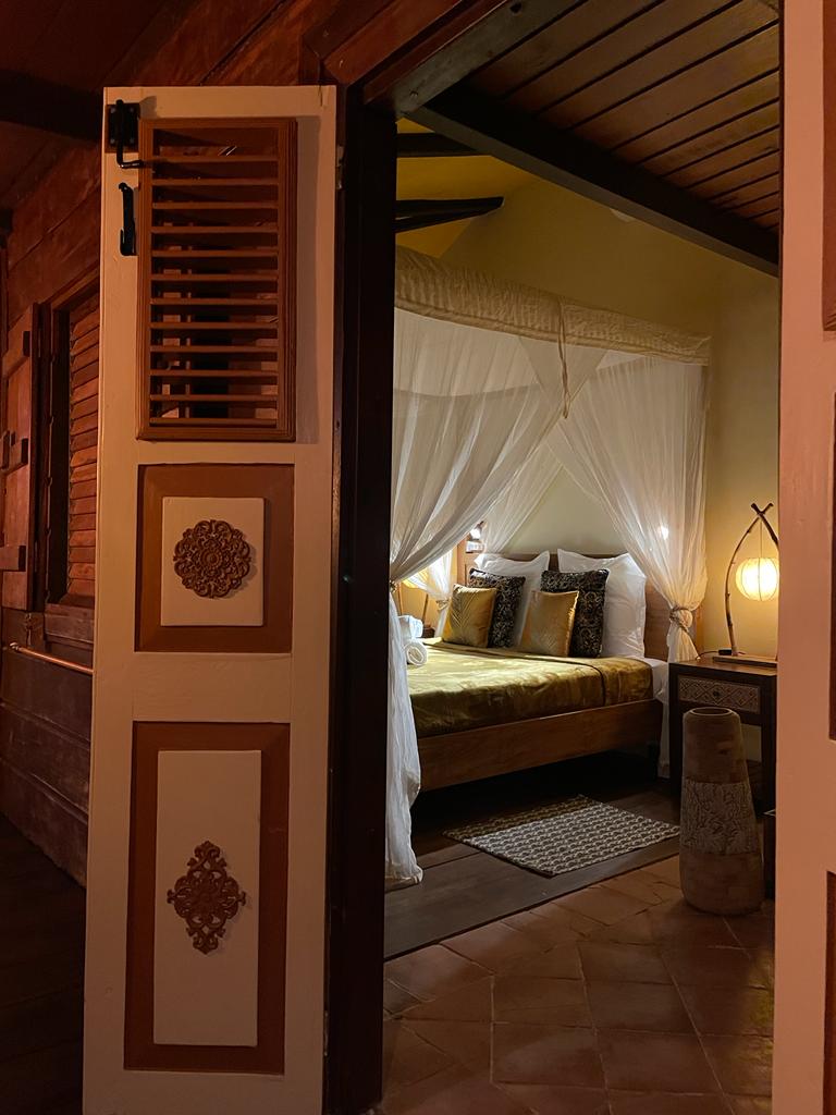 Two bedrooms with separate toilets and showers, queen-size bed, mosquito net, fan, and air conditioning.